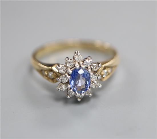 A modern 9ct gold, sapphire and diamond cluster ring, size O.